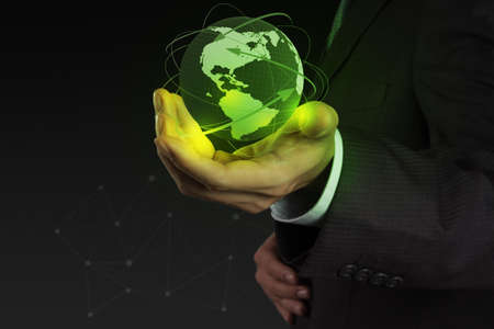 businessman hand working with new modern computer show the earth social network structureの写真素材