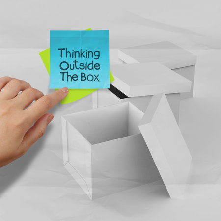thinking outside the box on crumpled sticky note paper as conceptの写真素材