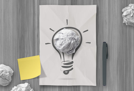 sticky note with another idea light bulb on crumpled paper as creative conceptの写真素材