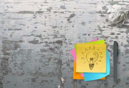 lightbulb as creative on crumpled sticky note paper on texture desk as concept