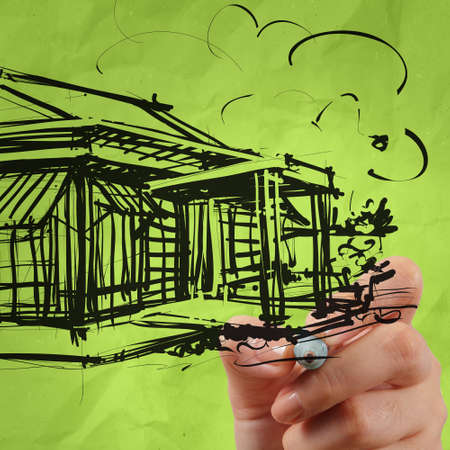 close up of hand house house on modern computer as development conceptの写真素材