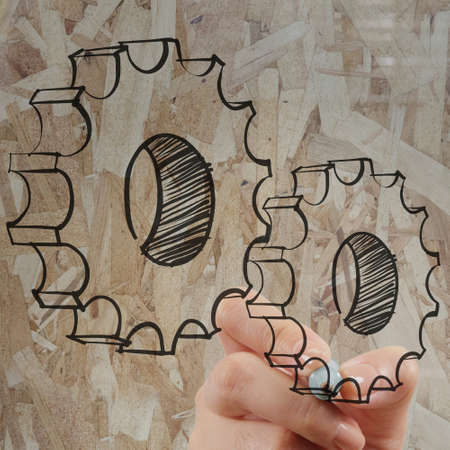 close up of hand draws gear to success as conceptの写真素材