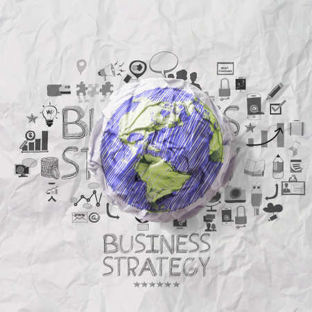 crumpled world and hand drawn business straegy on crumpled paper background  as conceptの写真素材