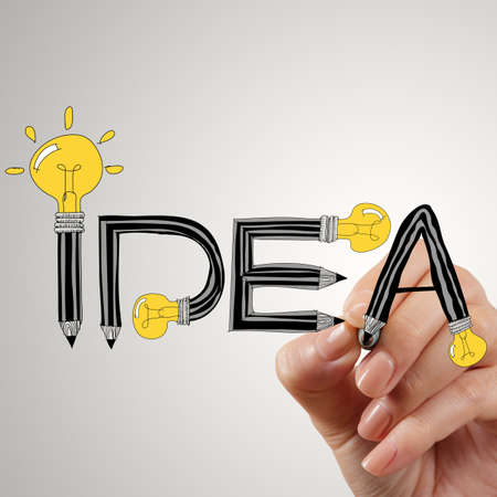 close up of hand writing idea design light bulb as conceptの写真素材