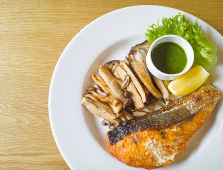 Grilled salmon steak and mushroomの写真素材