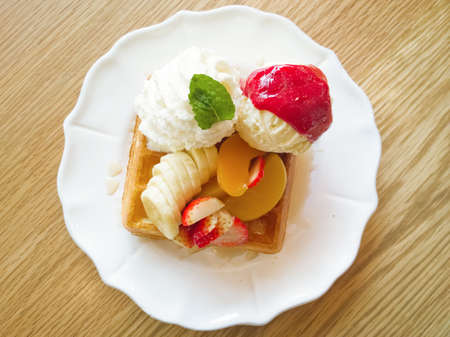 Waffle with fruits on wooden tableの写真素材
