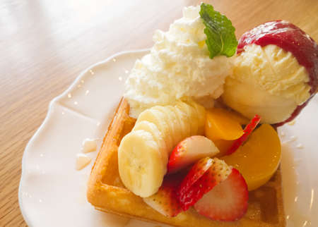 Waffle with fruits on wooden tableの写真素材