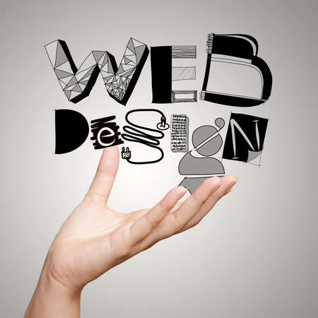 clouse up of  hand showing design word WEB DESIGN  as conceptの写真素材