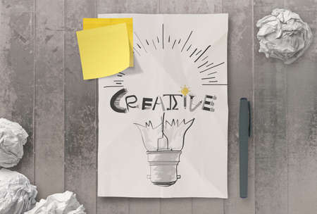  han drawn light bulb and CREATIVE word design on clumpled paper background  as conceptの写真素材