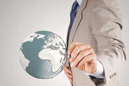businessman hand drawing abstract globe as conceptの写真素材