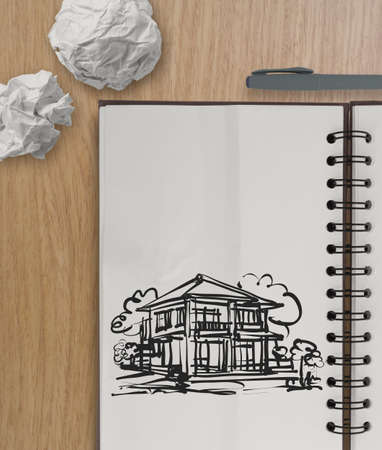 hand drawing house on wrinkled paper with wooden table as concept の写真素材