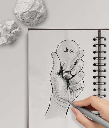 Hand drawn light bulb with IDEA word on note book as conceptの写真素材