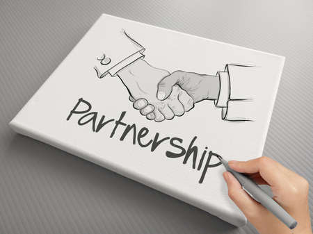 hand drawn handshake sign on canvas board as partnership business conceptの写真素材