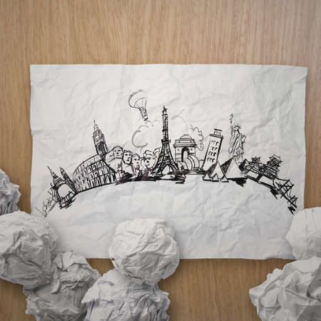 crumpled paper with hand drawn traveling around the world on wooden as concept の写真素材