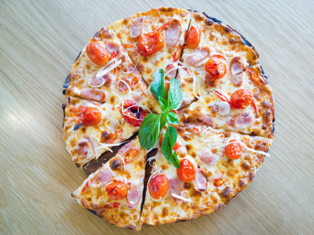 Pizza with ham, pepper and tomatoの写真素材