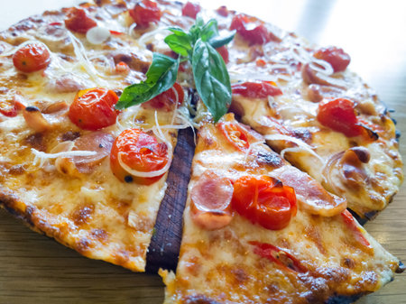 Pizza with ham, pepper and tomatoの写真素材