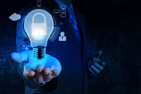 businessman hand show 3d light bulb  icon with padlock as Internet security online business concept の写真素材