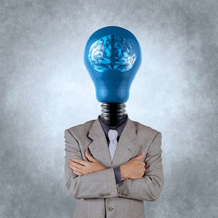 businessman with lamp-head 3d metal brain as concept の写真素材