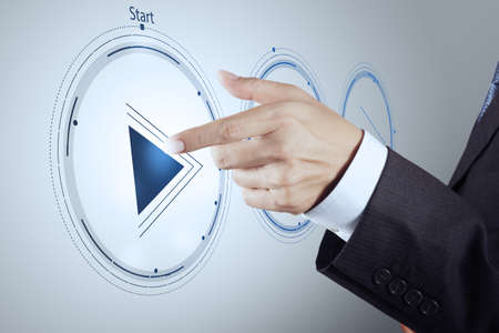 hand press play button sign to start or initiate projects as concept の写真素材