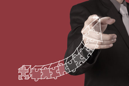 businessman hand puzzle charts with new modern computer and business strategy as concept の写真素材