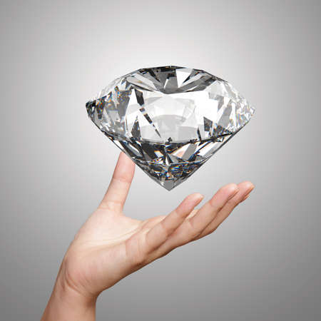 hand holding 3d diamond over white の写真素材