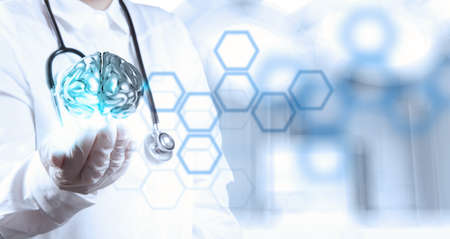 doctor neurologist hand show metal brain with computer interface as conceptの写真素材