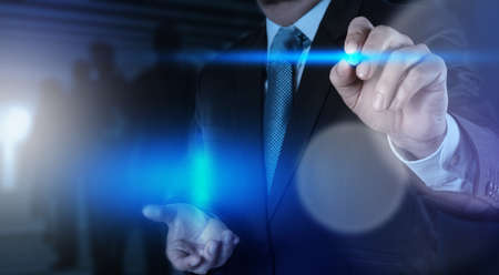 businessman hand pressing button with contact on virtual screens as concept の写真素材