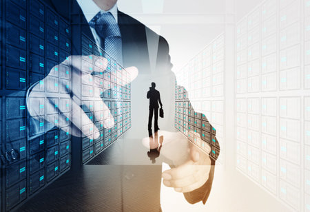 Double exposure of businessman hand pressing a touchscreen button on server backgroundの写真素材