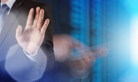  businessman hand pressing a touchscreen button on server backgroundの写真素材