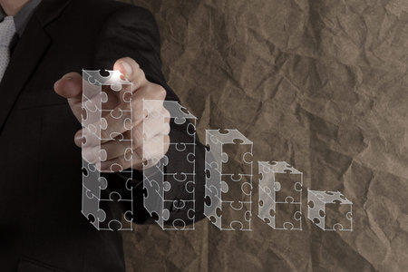 businessman hand puzzle charts with new modern computer and business strategy as conceptの写真素材