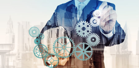 Double exposure of businessman hand draws gear to success concept