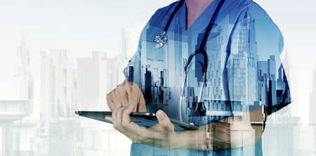 Double exposure of smart medical doctor working with abstract city as concept の写真素材