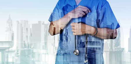 Double exposure of smart medical doctor working with abstract city as concept の写真素材