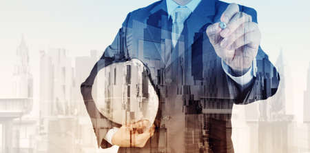 Double exposure of business engineer and abstract city as conceptの写真素材