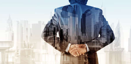 Double exposure of businessman and abstract cityの写真素材