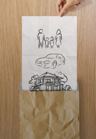 hand open crumpled paper to show planning family future on wood  background as conceptの写真素材