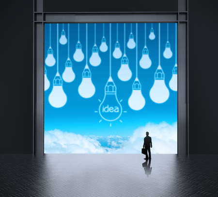 businessman looking at lightbulb as creative concept の写真素材