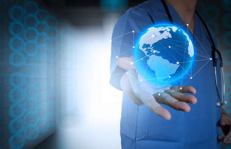 Medical Doctor holding a world globe in his hands as medical network concept の写真素材
