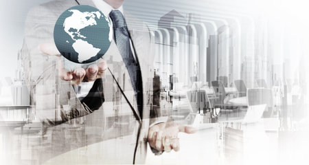 Double exposure of business  holding the earth and abstract city as concept 