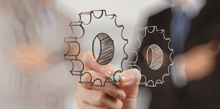 businessman hand draws gear to success conceptの写真素材