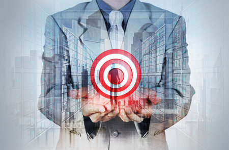 Double exposure of businessman hand shows target symbol as business conceptの写真素材