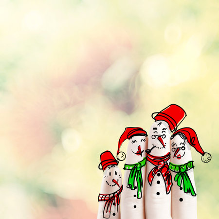 A lovely family hand drawn and finger of snowmen on flowers nature background as concept ideaの写真素材