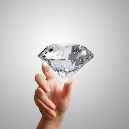hand holding 3d diamond over white backgroundの写真素材