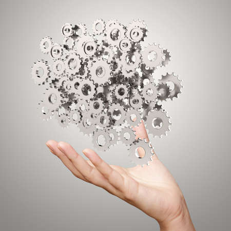 businessman hand showing gears cogs to success conceptの写真素材