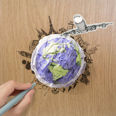 hand drawn traveling around the world by air plane on wood backgroundの写真素材