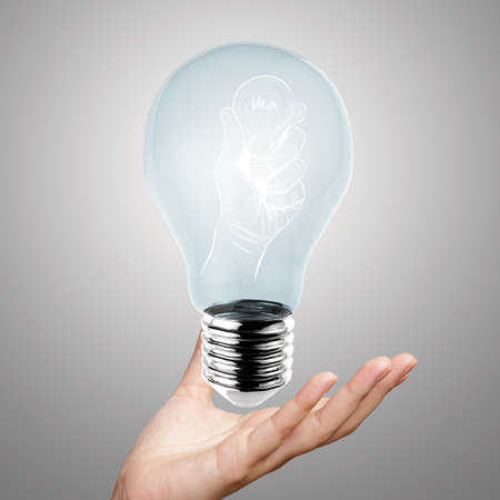 hand reach light bulb of leadership conceptの写真素材