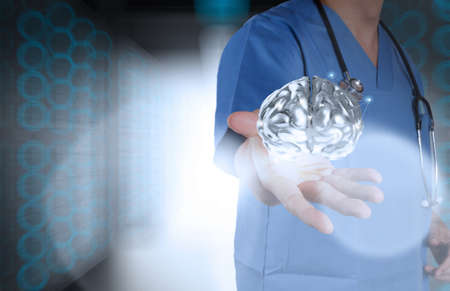 doctor neurologist hand show metal brain with green background as conceptの写真素材
