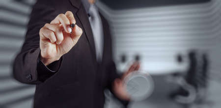 Businessman hand pressing an imaginary button on virtual screenの写真素材