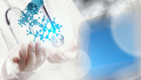 scientist doctor hand holds virtual molecular structure in the lab as conceptの写真素材