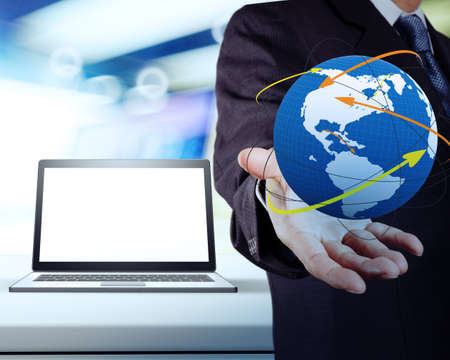 businessman hand showing the world and blank laptop computer in shop background as conceptの写真素材